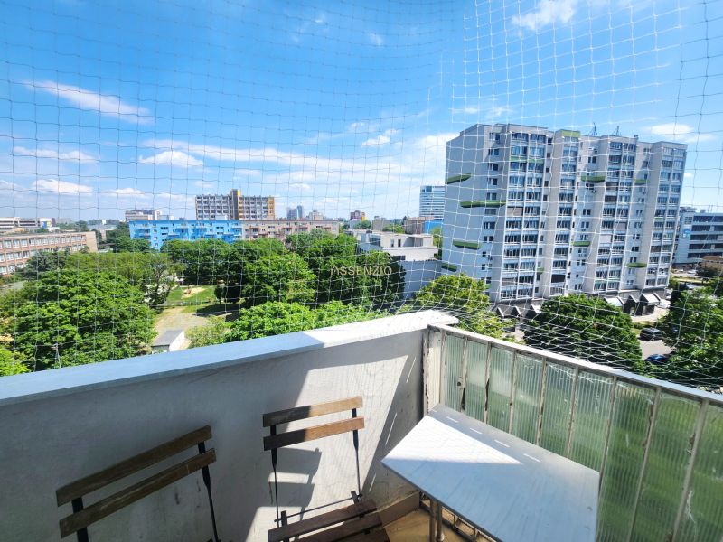 View from the balcony of greenery, tall buildings, and clear skies in Bratislava - Ružinov.
