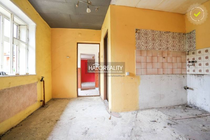 An abandoned room with colorful walls and a window in a family house.