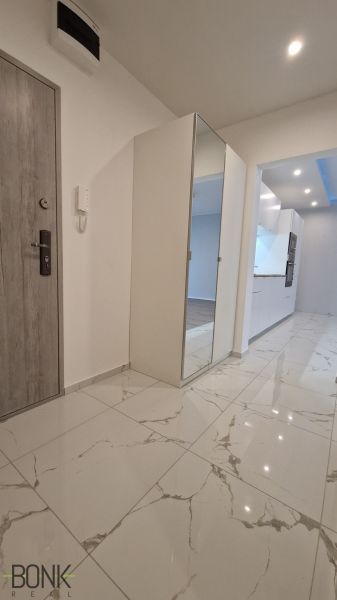 Entrance hallway in a 2-room apartment with ceramic flooring and a built-in wardrobe.