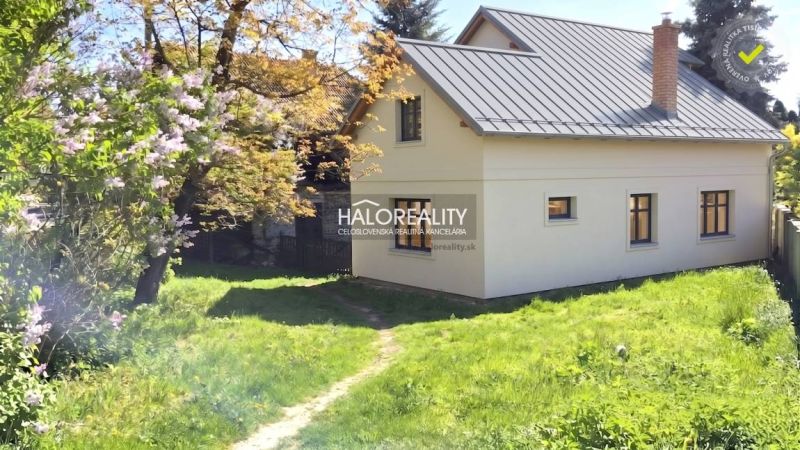 A family house in Poltár with a garden, surrounded by greenery and flowers.
