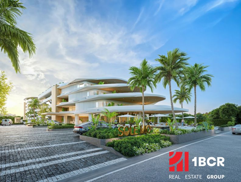 Apartment construction in Phuket with modern architecture, surrounded by palm trees and parking space.