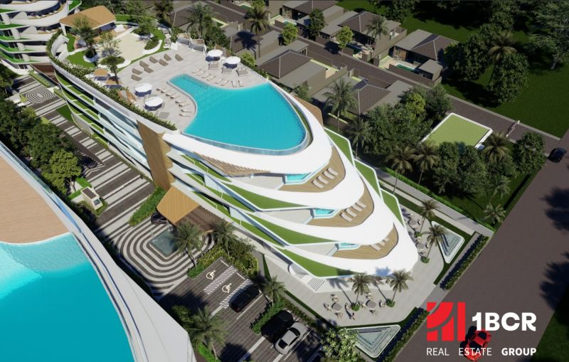 Apartment construction in Phuket with rooftop pools and tropical greenery.