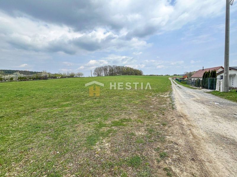 Extensive green plots suitable for living in the village of Bukovec under partly cloudy weather.