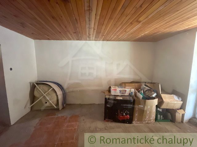 Basement of a family house with a wooden ceiling and stored boxes.