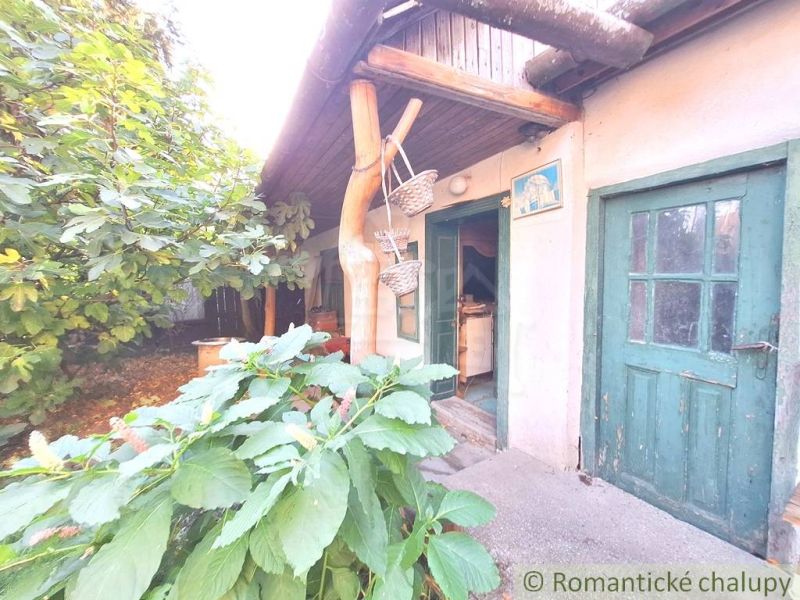 An old family house in Gbelce with a wooden veranda and green doors.