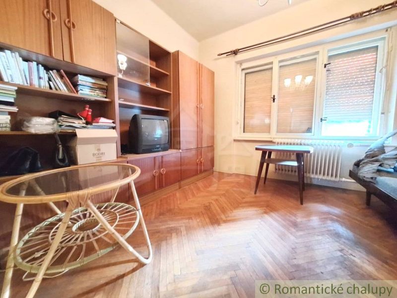 Living room in a family house with furniture and flooring featuring a wood design.