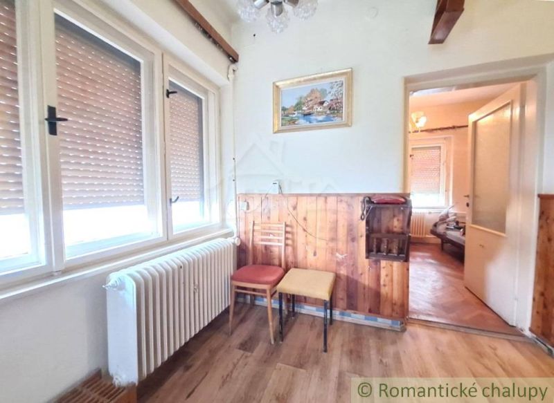 Interior of a family house with a wooden decor floor and a painting on the wall.