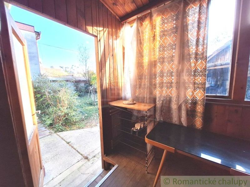 Interior of a family house with a wooden decor floor and a view of the garden.