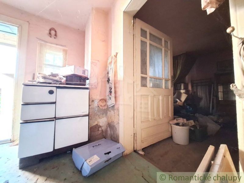The interior of a family house with a vintage stove and old doors with glass panels.