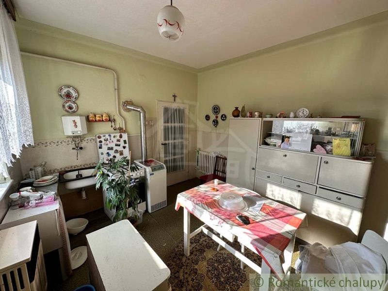 A kitchen in a family house with retro furniture and decorations.