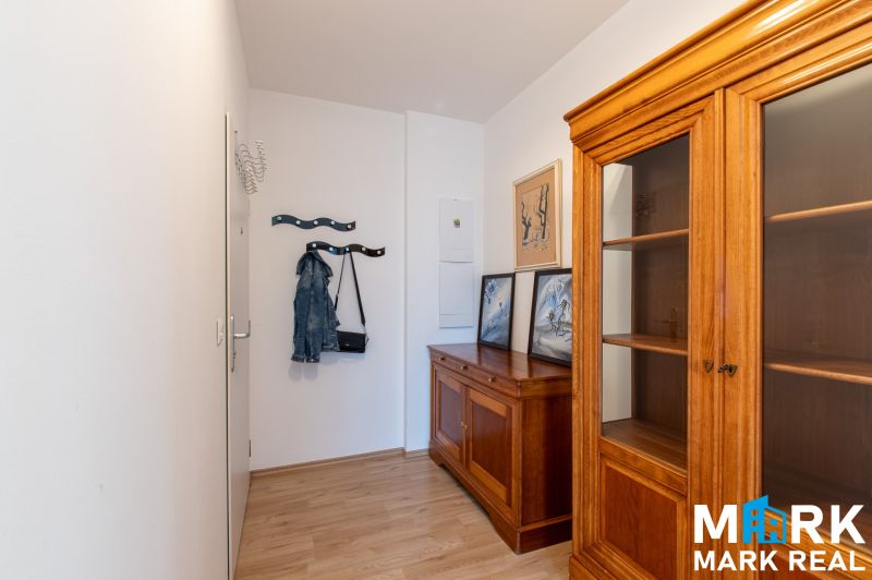 Interior of a 2-room apartment with wooden furniture and flooring with a wooden decor.