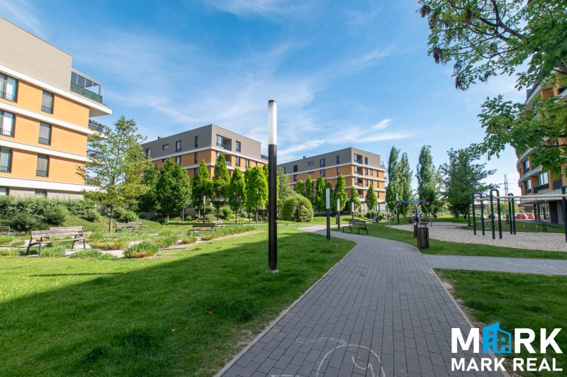 Buildings surrounded by greenery and a walkway on Bajkalská in Bratislava, suitable for a 2-room apartment.