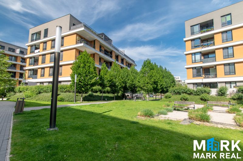 Residential complex on Bajkalská Street in Bratislava, with greenery and benches in the courtyard.