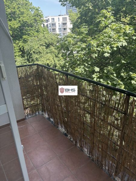 A balcony with a view of greenery in a 2-room apartment on Dobrovského Street, Bratislava Old Town.