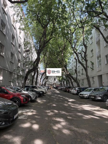 Parking between trees on Dobrovského Street in Bratislava's Old Town, surrounded by 2-room apartments.