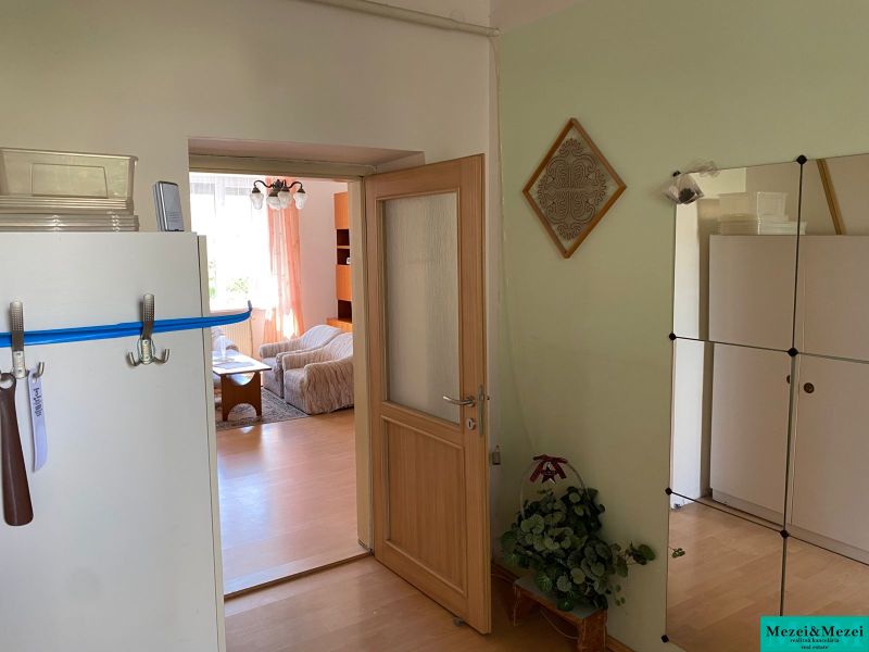 Interior of a 2-room apartment with a wooden decor floor, visible living room.