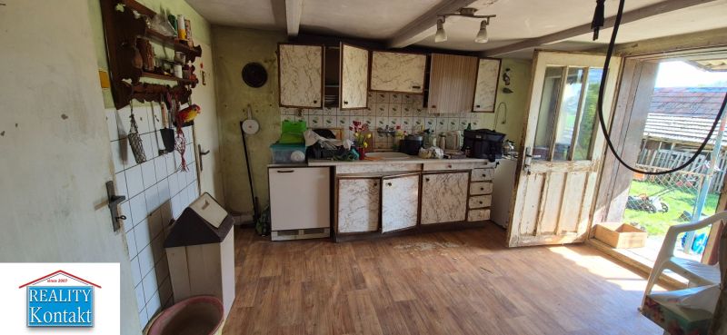 A kitchen space in a family house with a wooden decor floor and rustic decoration.