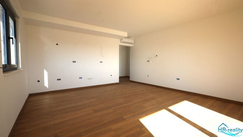 A bright room with a wooden decor floor in a holiday apartment.