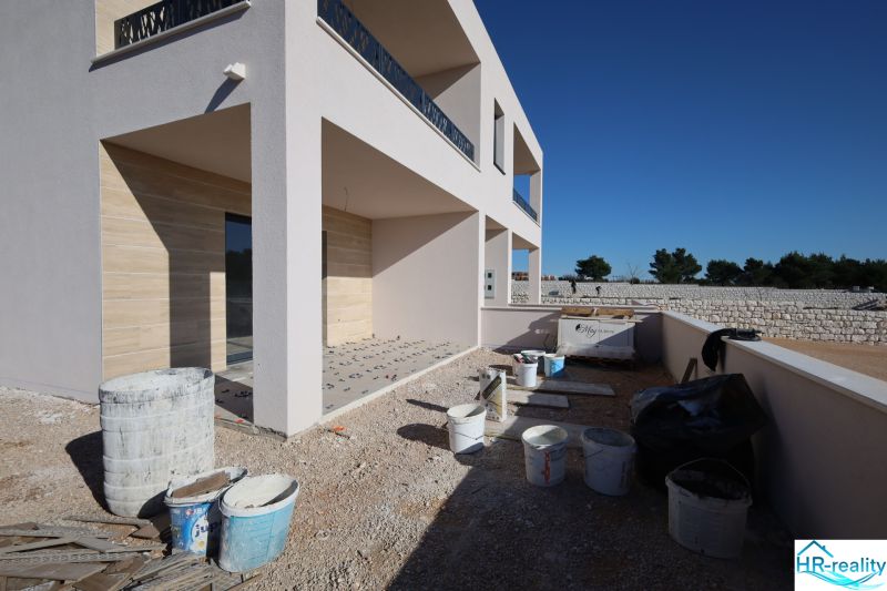 A recreational apartment in Vodice under construction, with a terrace and building materials around.