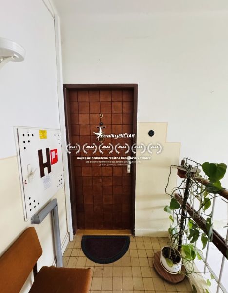 Entrance door of a three-room apartment number nine, leading to the staircase.