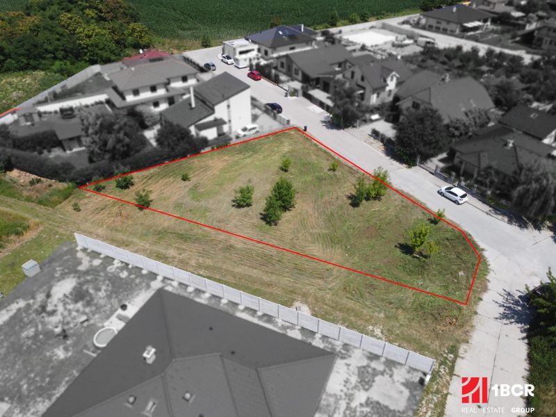 Plots - residential area in Zálesie on Cintorínska Street with young trees and grassy area.