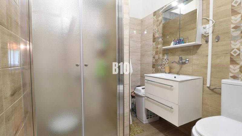 Bathroom in a family house with a sink and a shower.