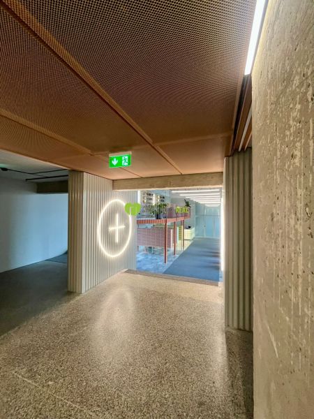 A corridor with an emergency exit and a sign in the building on Kysucká Street in Košice, West district.