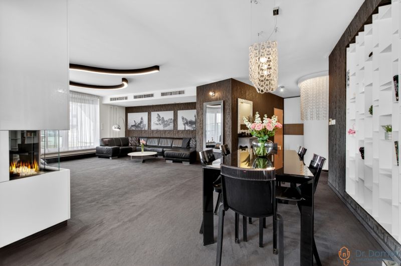 Living room with a sofa, dining table, and fireplace in a 4-room apartment.