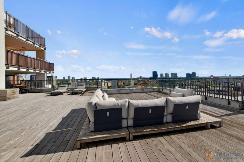 Rooftop terrace in Bratislava - Ružinov on Jégého with a view of the city and seating.