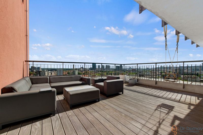 Terrace with seating and a view of the city in Bratislava on Jégého in a 4-room apartment.