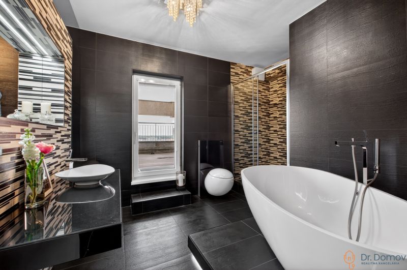 Luxury bathroom with a freestanding bathtub and decorative tiles in a 4-room apartment.