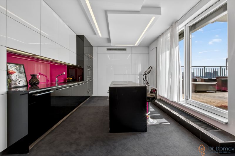 A stylish kitchen with colorful tiles and large windows in a 4-room apartment.