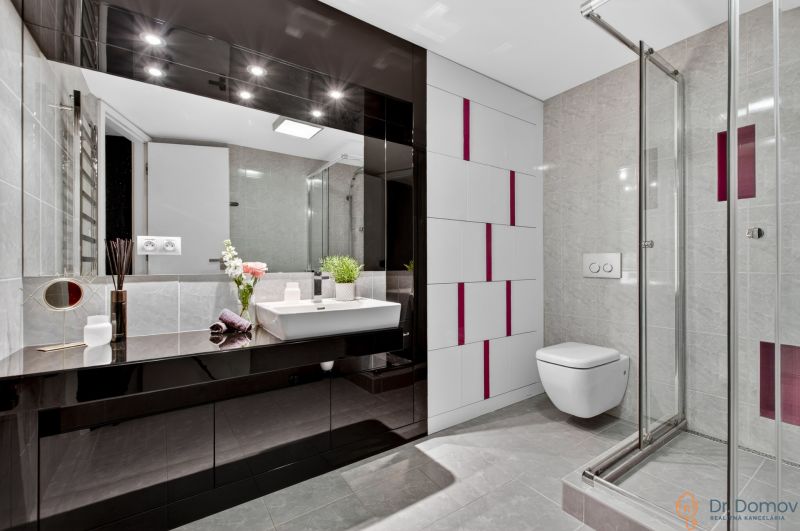 Bathroom in a 4-room apartment with glossy tiles, a shower corner, and a sink.