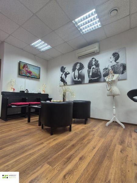 Interior of commercial spaces with wood-patterned flooring and artistic photographs.