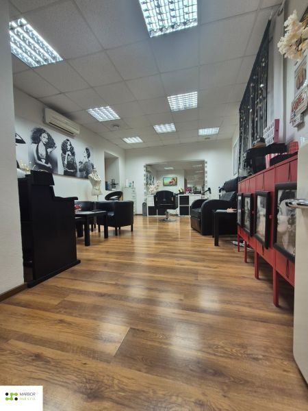 Interior of commercial spaces with wood-patterned flooring and interior furniture.