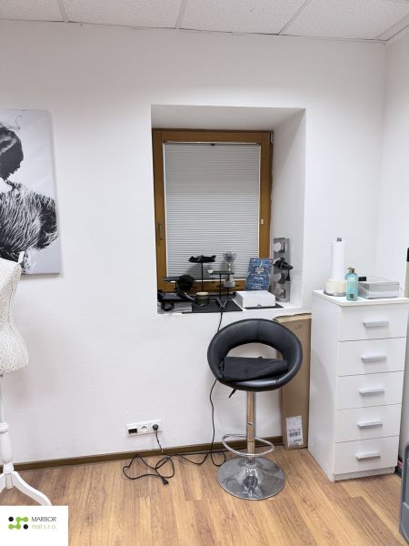 A chair and a side cabinet in commercial premises with a wooden decor floor.