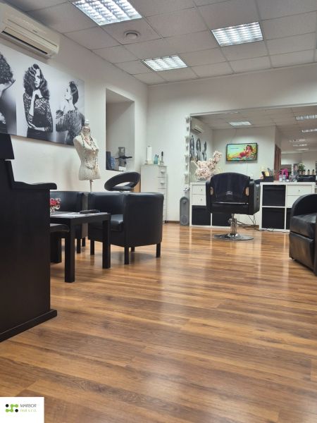 Commercial space with armchairs and wooden decor flooring, comfortable seating.