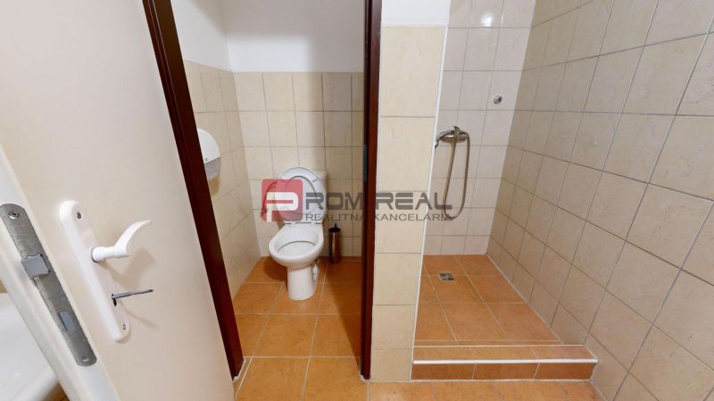 Toilet and shower corner with ceramic tiles in the Warehouse and hall areas.