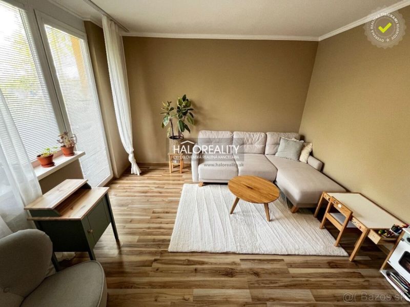 Living room of a three-room apartment with a comfortable sofa and a floor with a wooden decor.