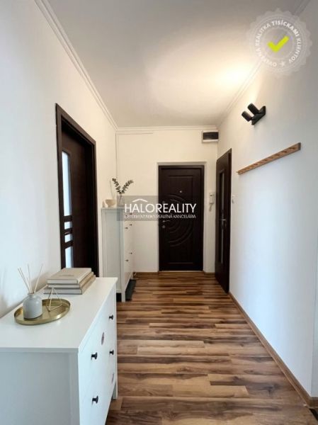 Interior of a 3-room apartment with wood-patterned flooring and modern furniture.