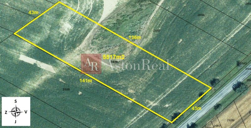 Aerial view of residential land in the village of Svinná with a road on Svinná Street.