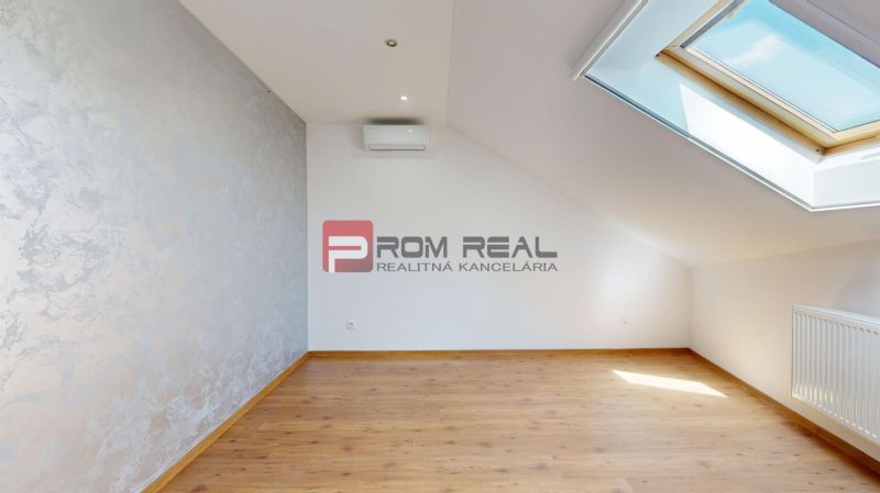 Interior of a family house with a wooden decor floor and a skylight.
