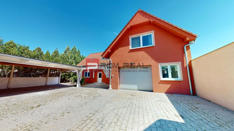 Family house on Gútorská Road in Šamorín with a light facade and a garage.