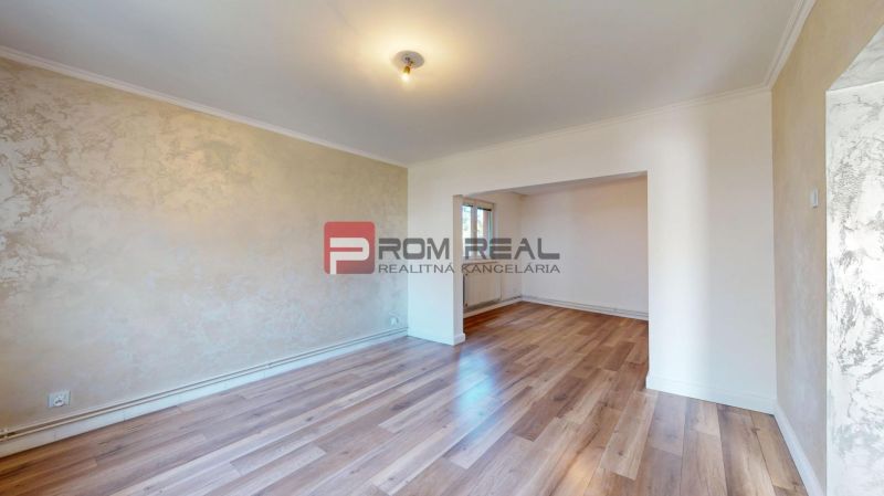 Interior of a family house with a wooden decor floor and light walls.