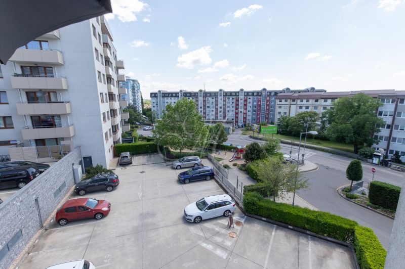 View from a 2-room apartment on Kadnárova Street in Bratislava - Rača with a parking lot.
