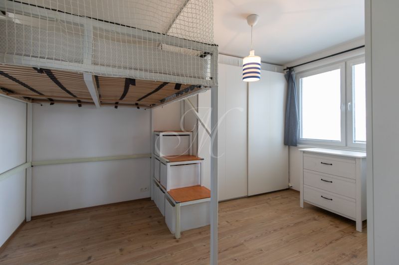 Children's room in a two-room apartment with a bunk bed and a floor with a wooden decor.