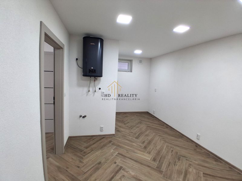 Commercial premises with white walls and wood-patterned flooring, equipped with a boiler.