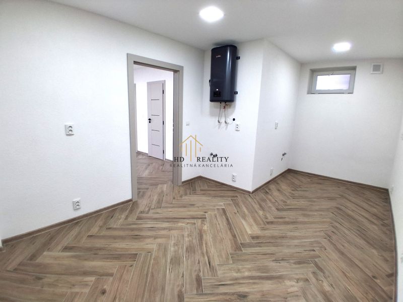 Commercial premises with wood-patterned flooring and a wall-mounted boiler.