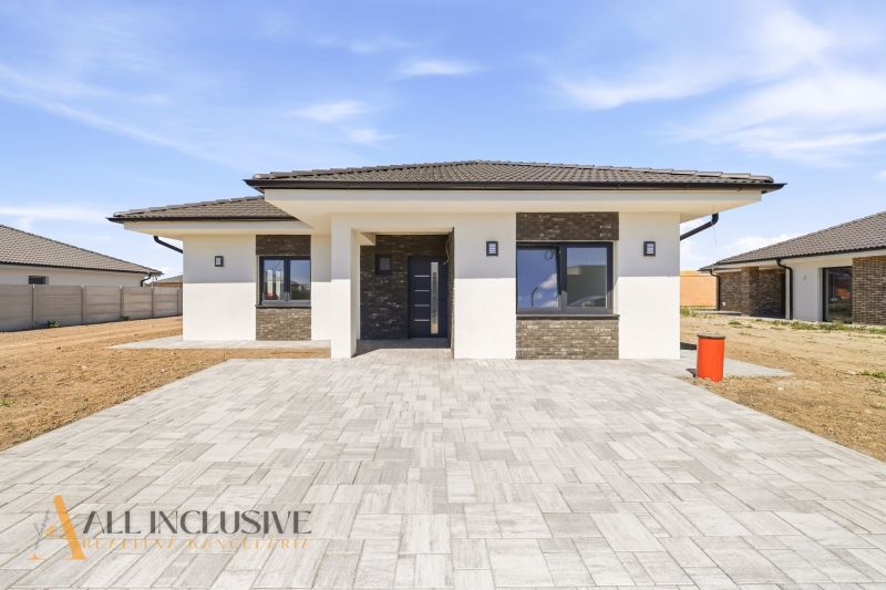 A family house in Hviezdoslavov with a paved courtyard and a contrasting facade.