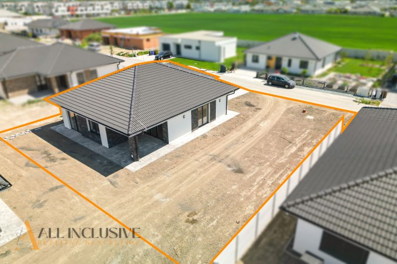 A family house in Hviezdoslavov with a large undeveloped plot and a black roof.